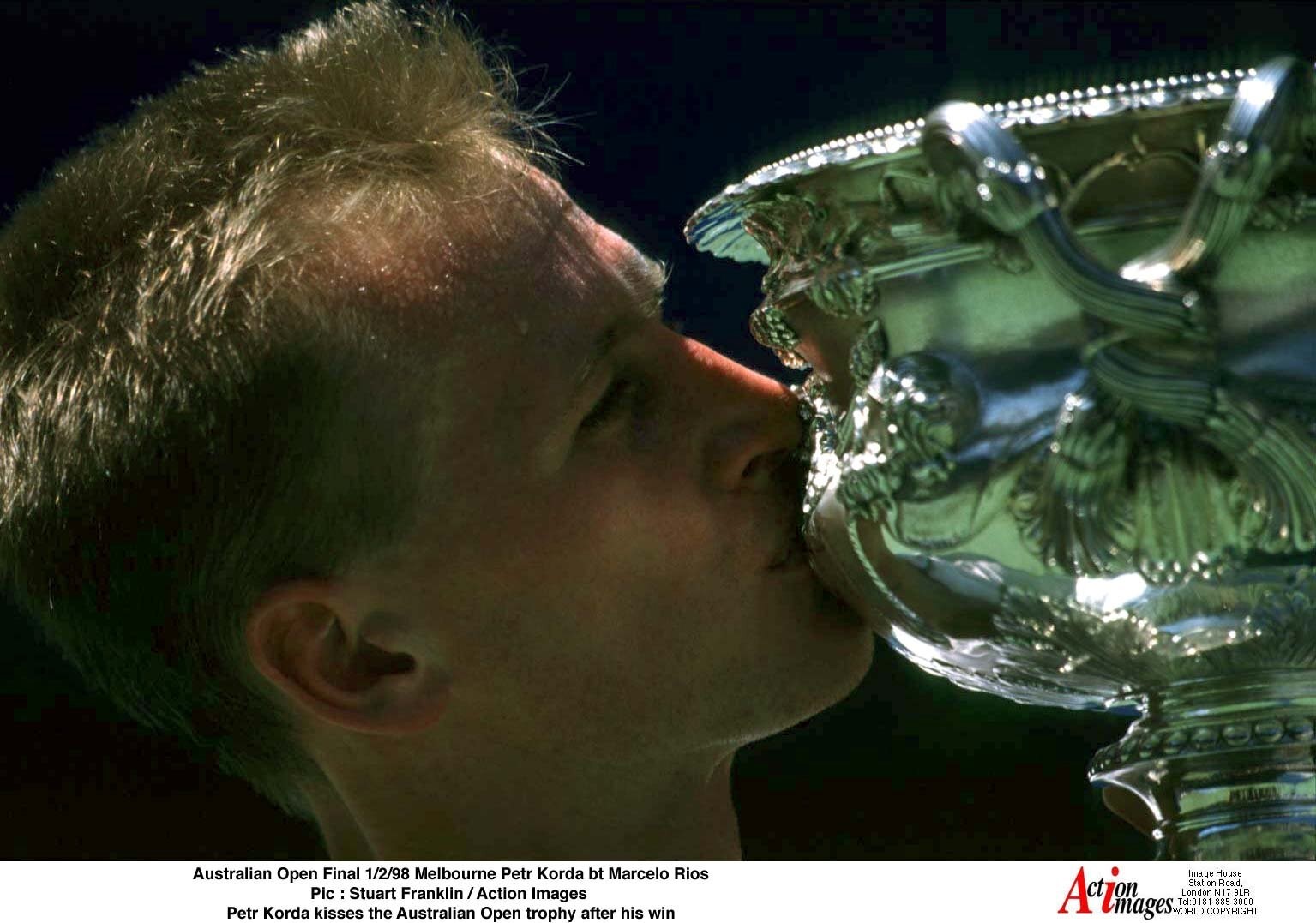 Petr Korda kisses a trophy.