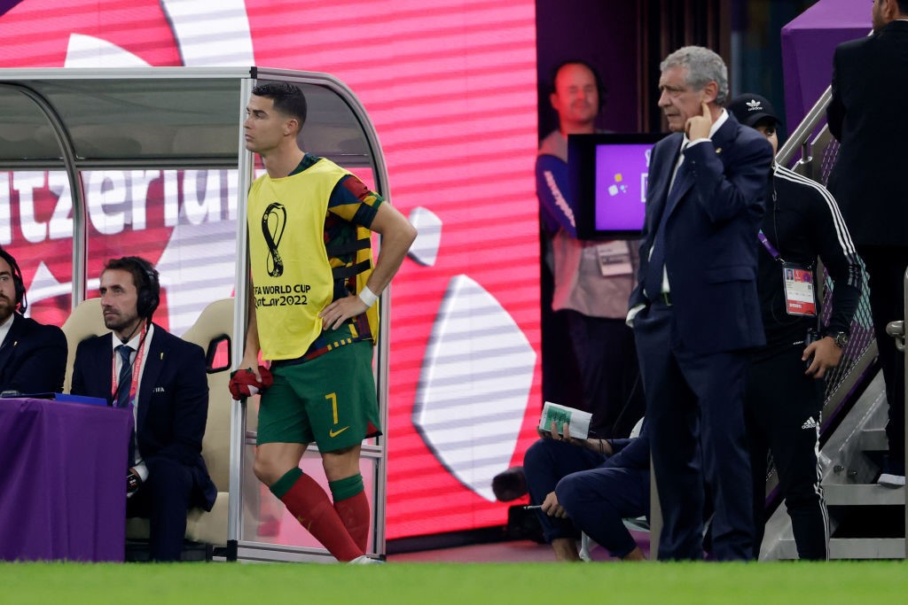 Cristian Ronaldo stands on the sidelines next to Portugal manager Fernando Santos during their Qatar World Cup match against Switzerland.