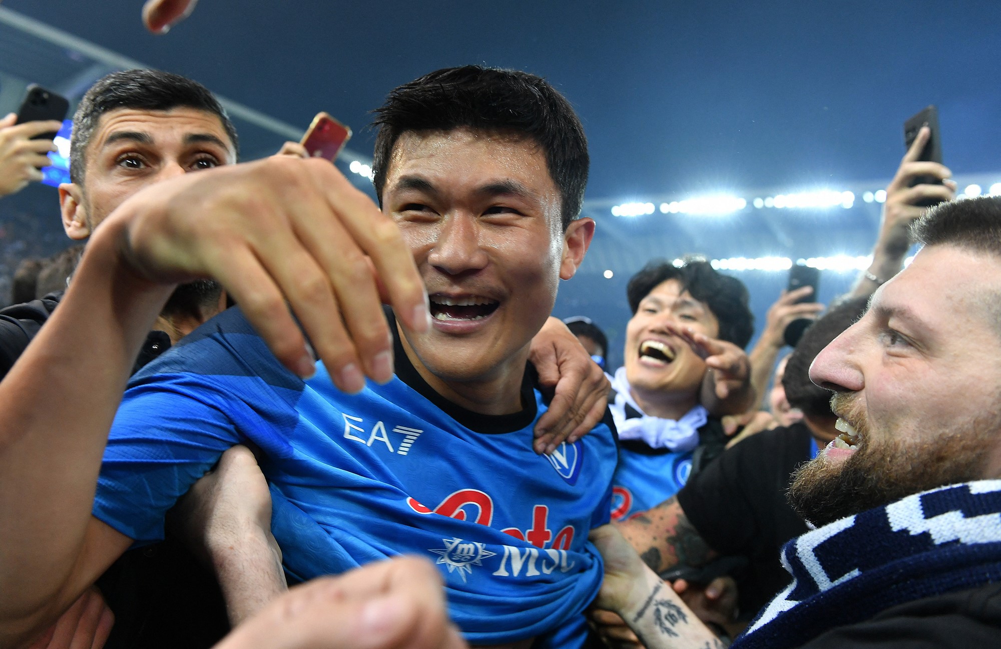 Napoli's Kim Min-jae celebrates with fans on the pitch