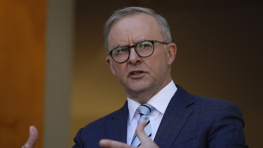 A close up of Albanese gesturing as he speaks.