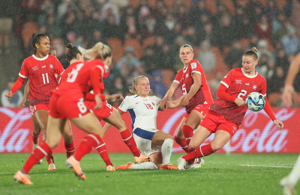 Frida Maanum of Norway is surrounded by Swiss defenders in the rain at the Women's World Cup.