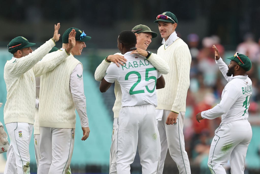 Kagiso Rabada hugs Rassie van der Dussen after he caught out Travis Head during a Test against Australia.