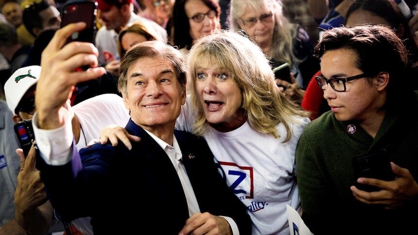 Oz takes a selfie with a supporter.