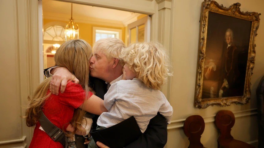 Boris Johnson hugs his wife and child