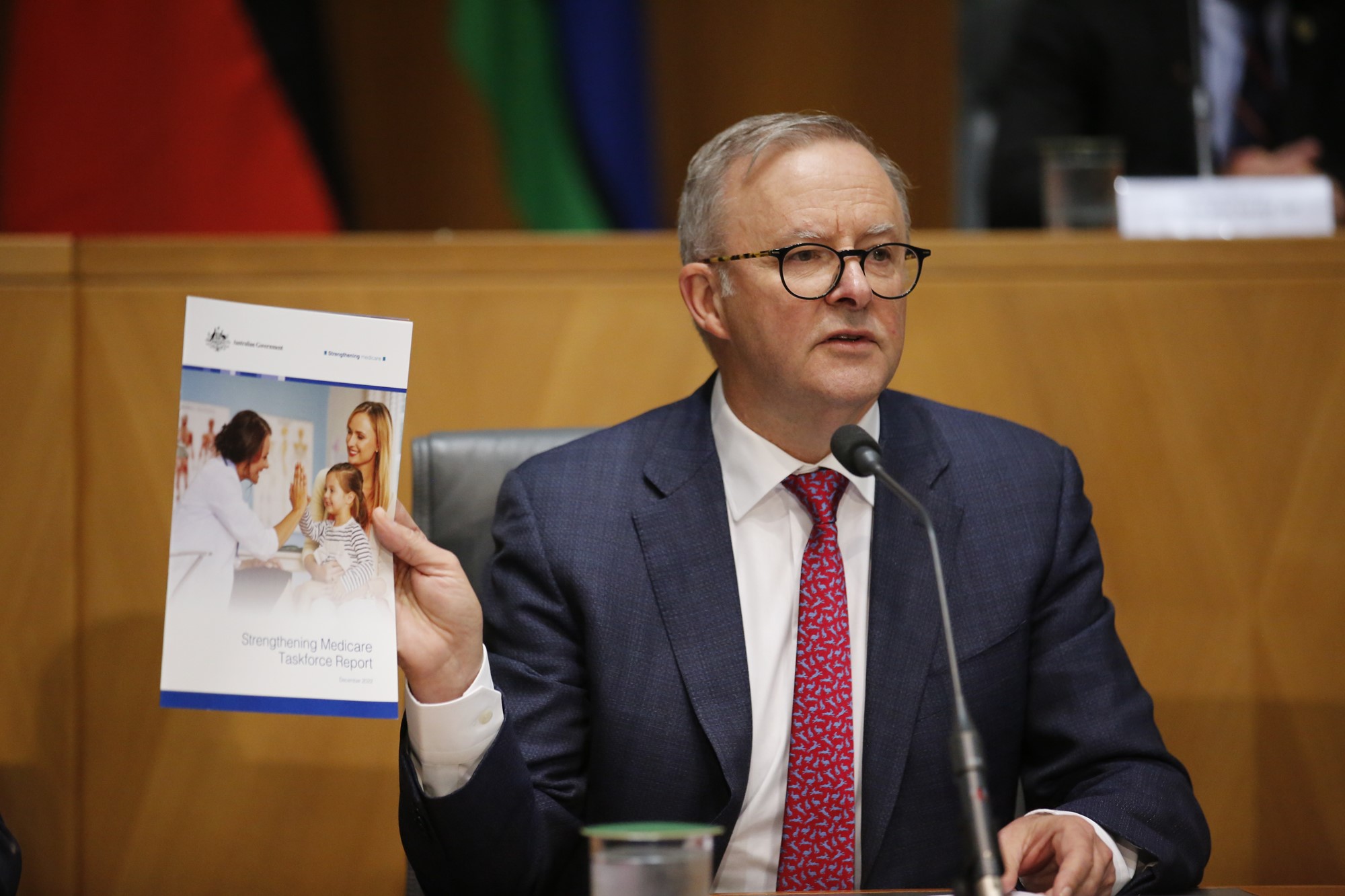 Anthony Albanese holds up the medicare report