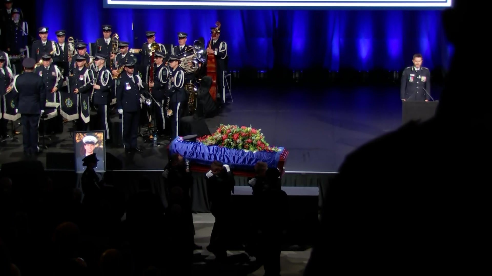 Six officers carry a casket