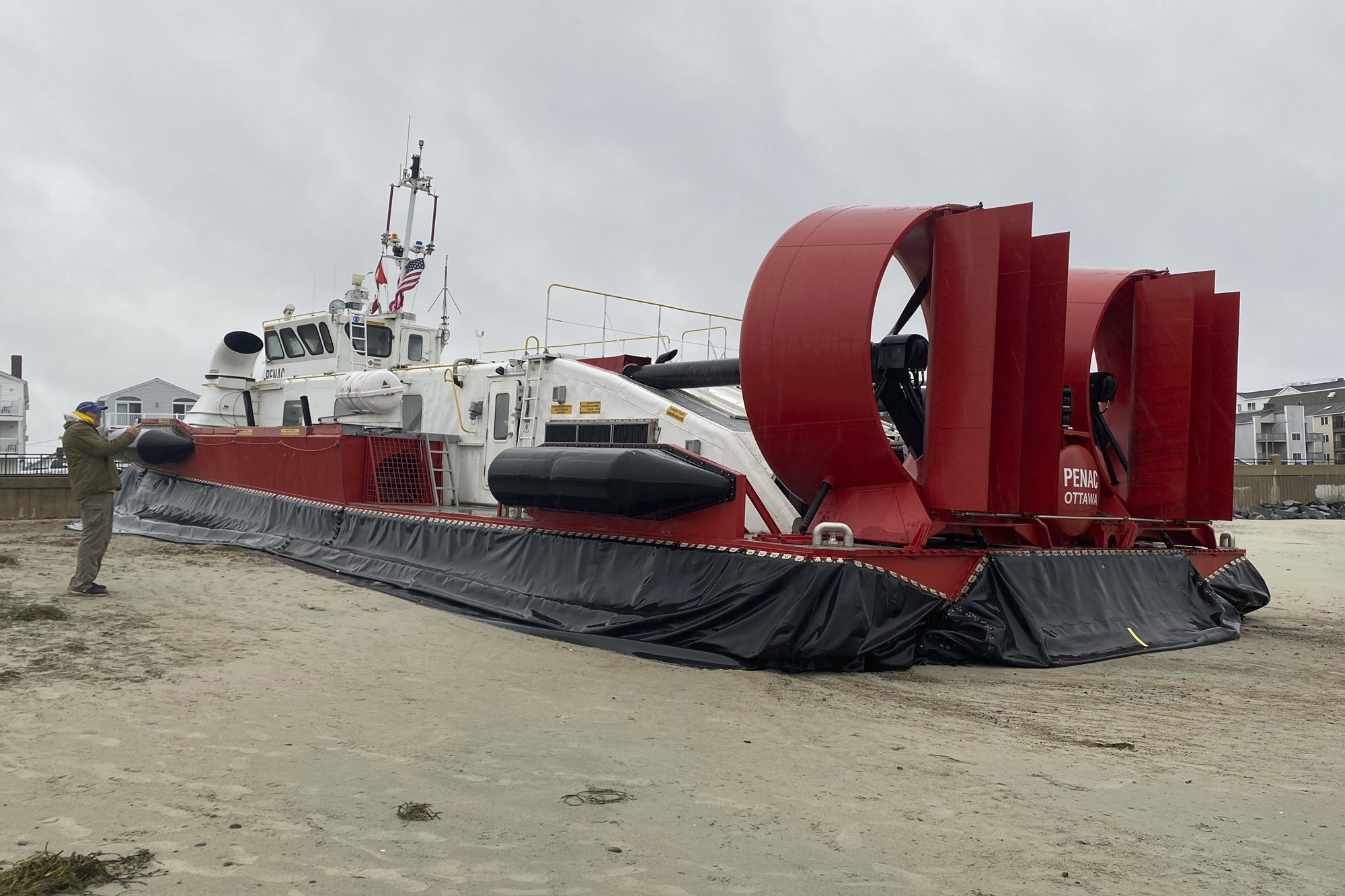 a beached hovercraft with tear in skirt 
