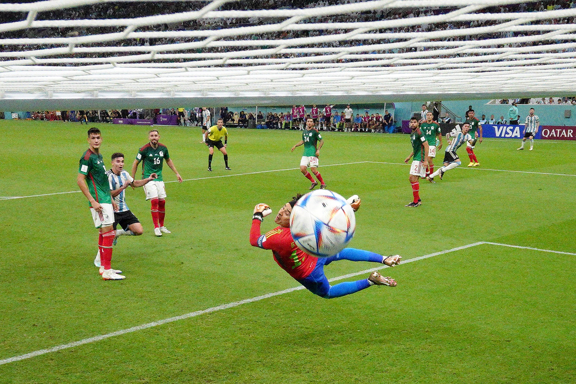 The ball flies past Mexican keeper Guillermo Ochoa for a goal from Argentina's Enzo Fernandez