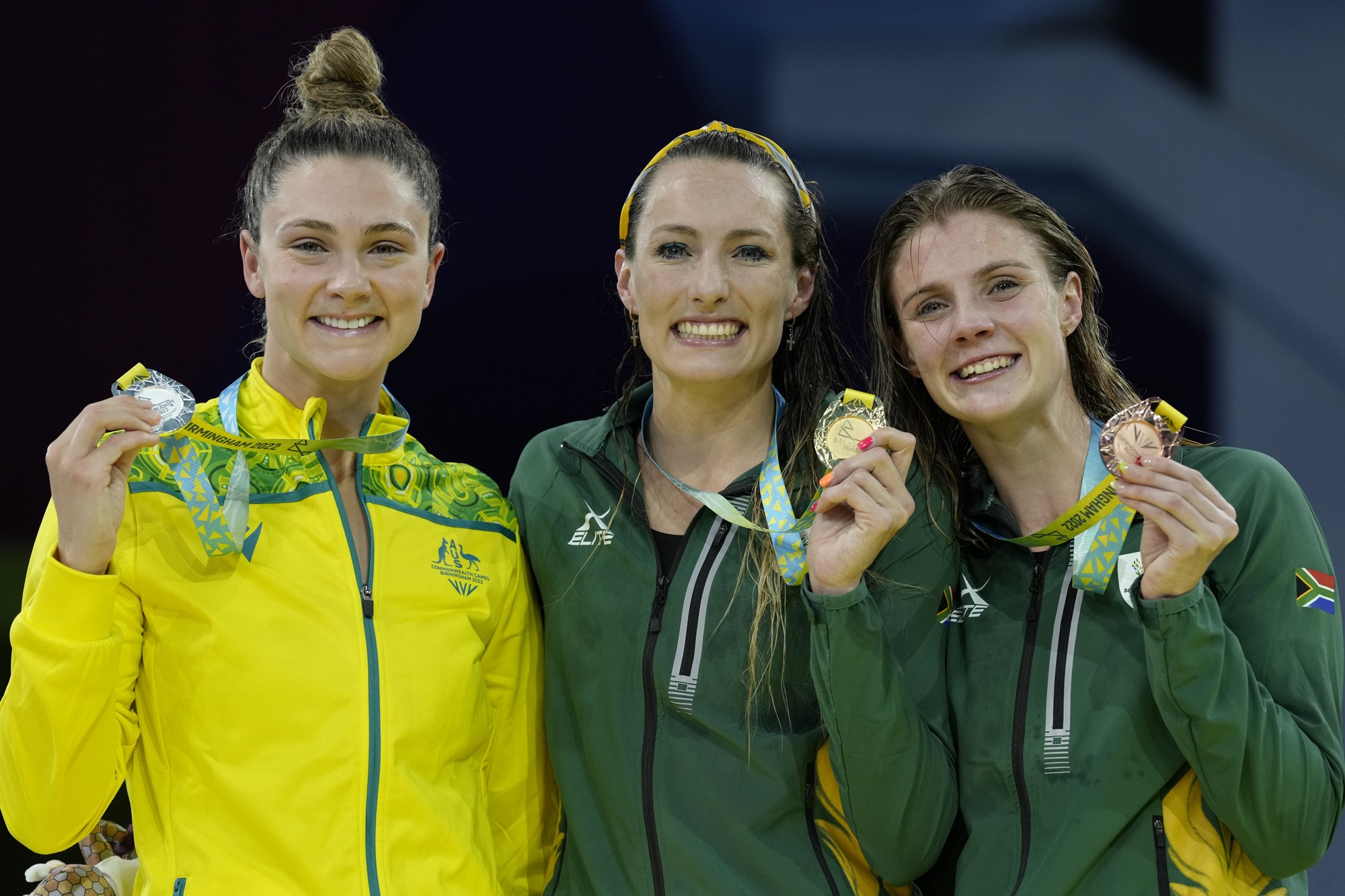Tatjana Schoenmaker, gold centre, with Australia's Jenna Strauch, silver, left, and Kaylene Corbett, bronze pose on the podium
