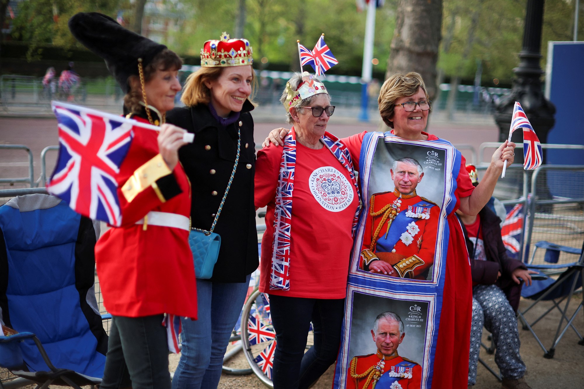 Royal fans in royal outfits stand together for a photo on the Mall in London