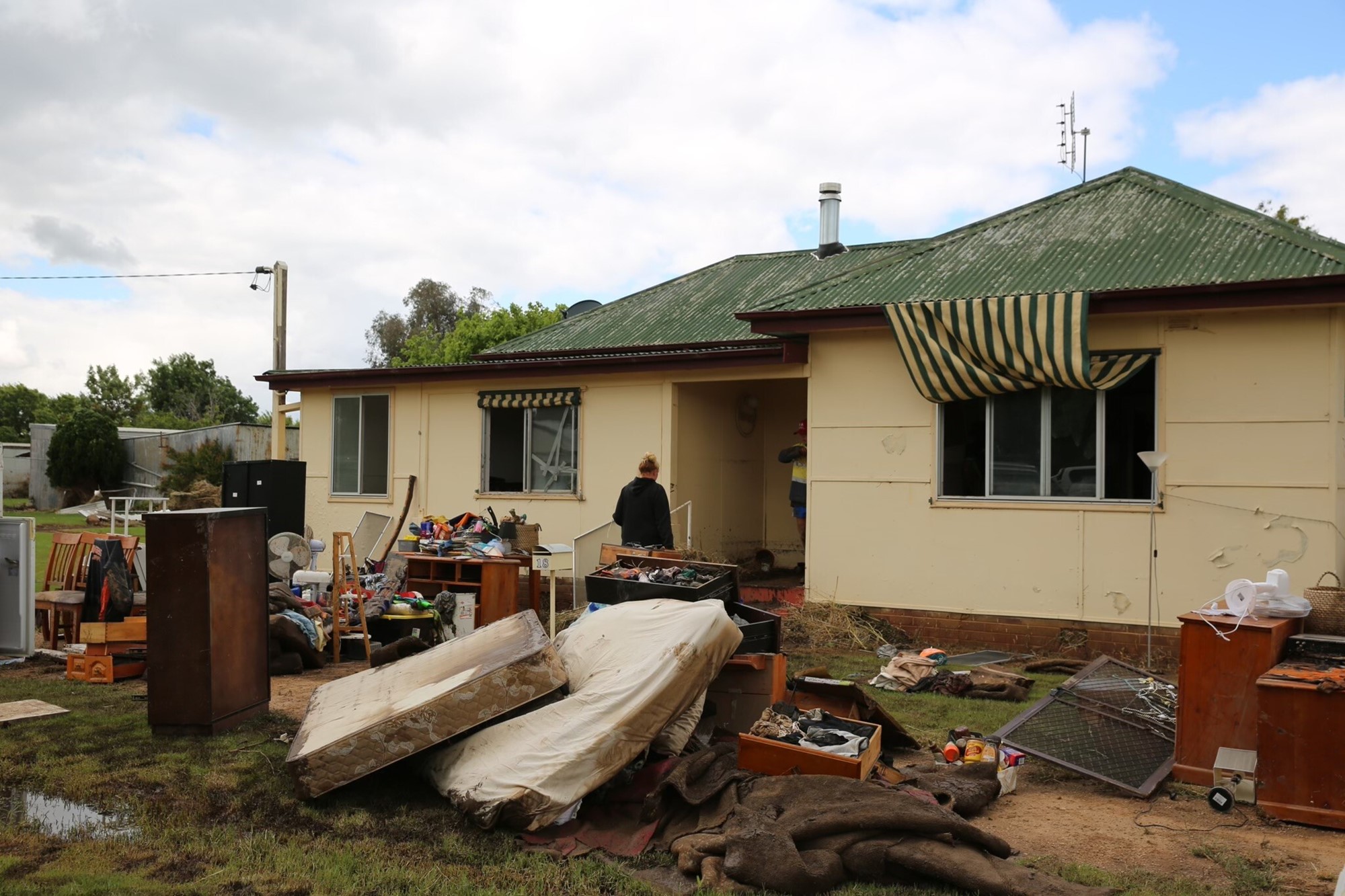 A house with its ruined contents on the front lawn 