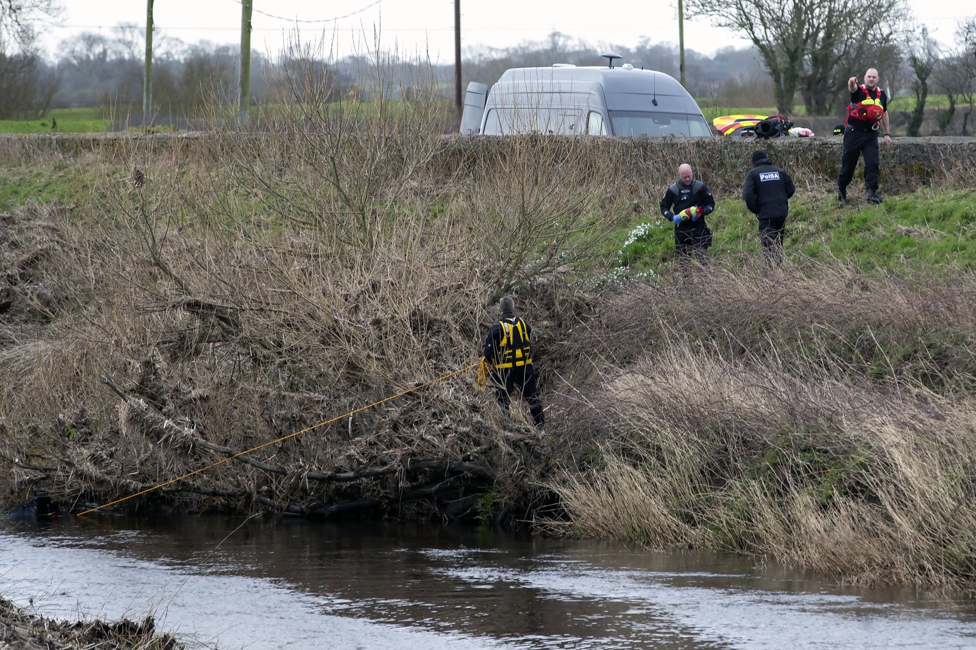 A police diving team works at the River Wyre.