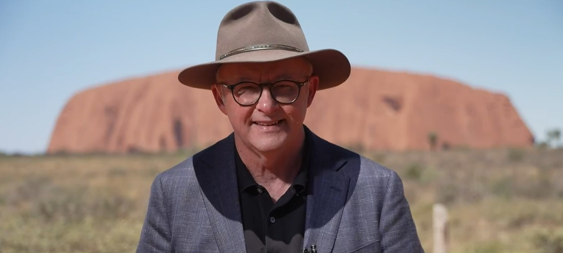 Albanese stands in front of Uluru.