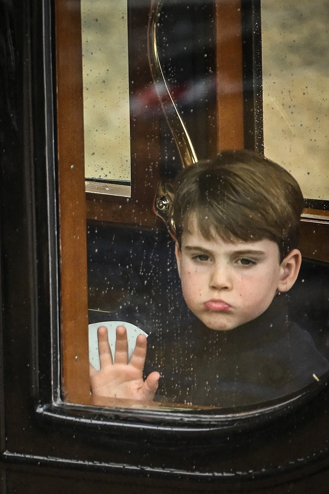 Prince Louis presses the hand to the window of the carriage