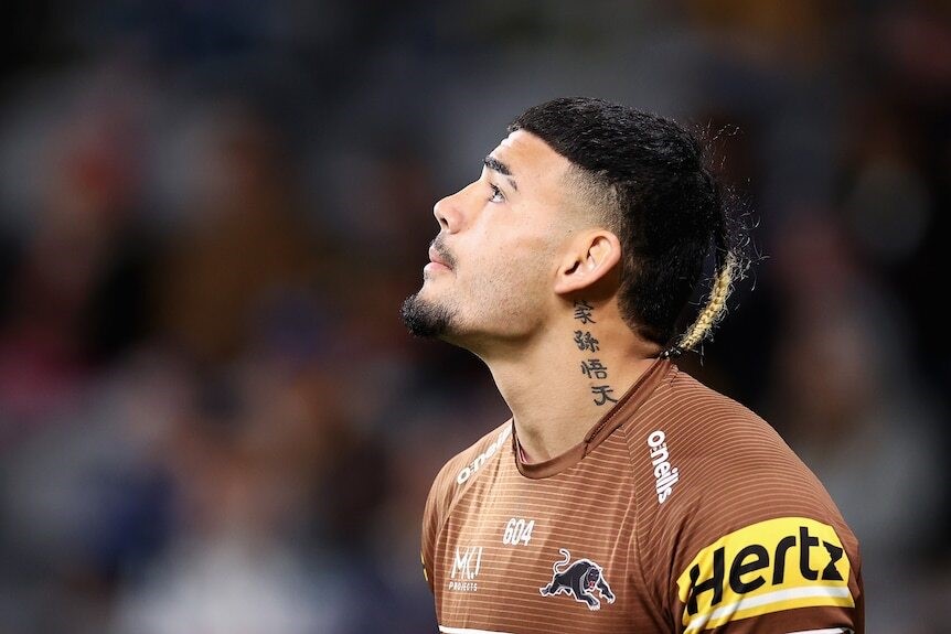 taylan may looks upwards while playing rugby league