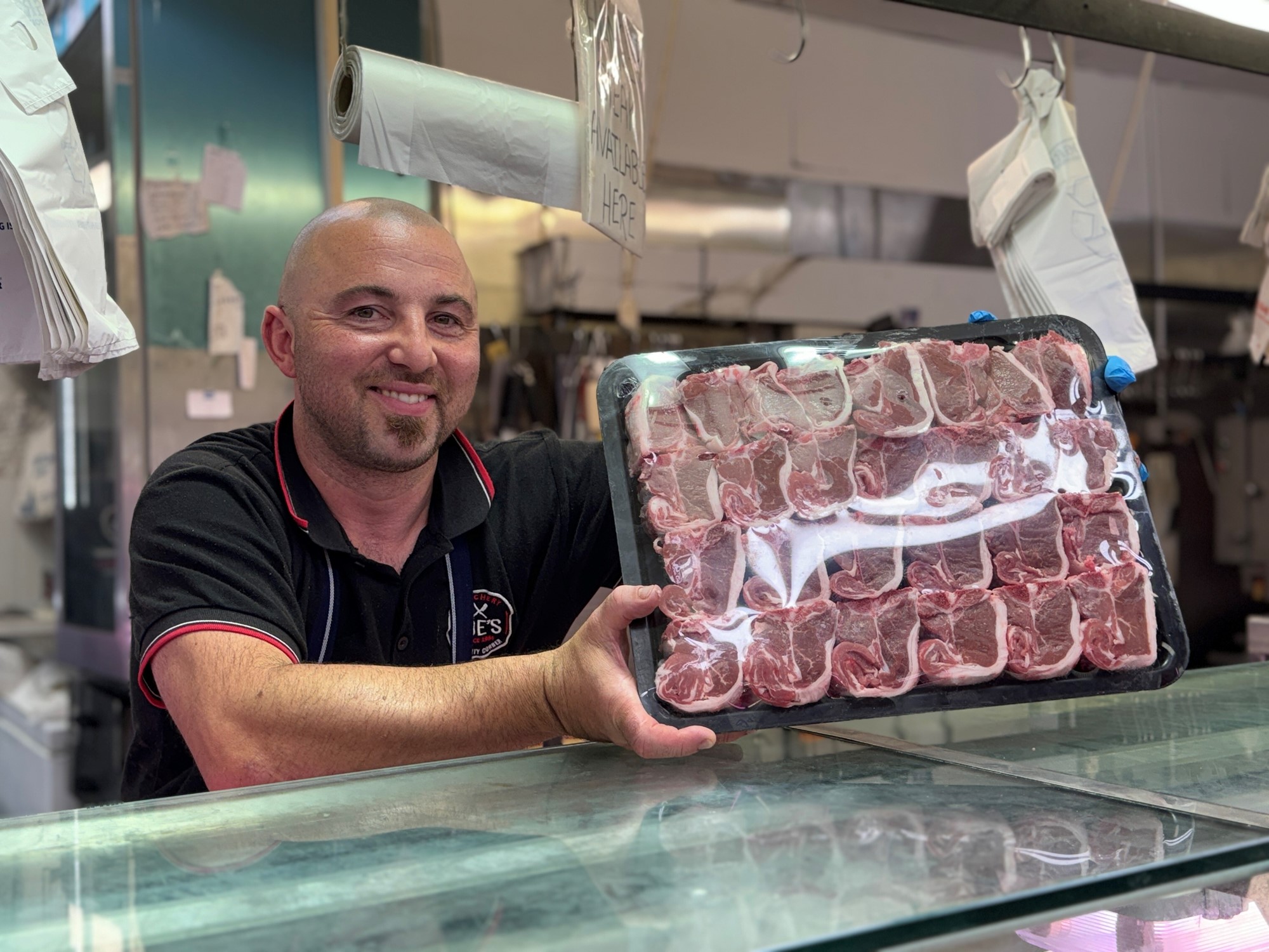 a man holding tray of meat