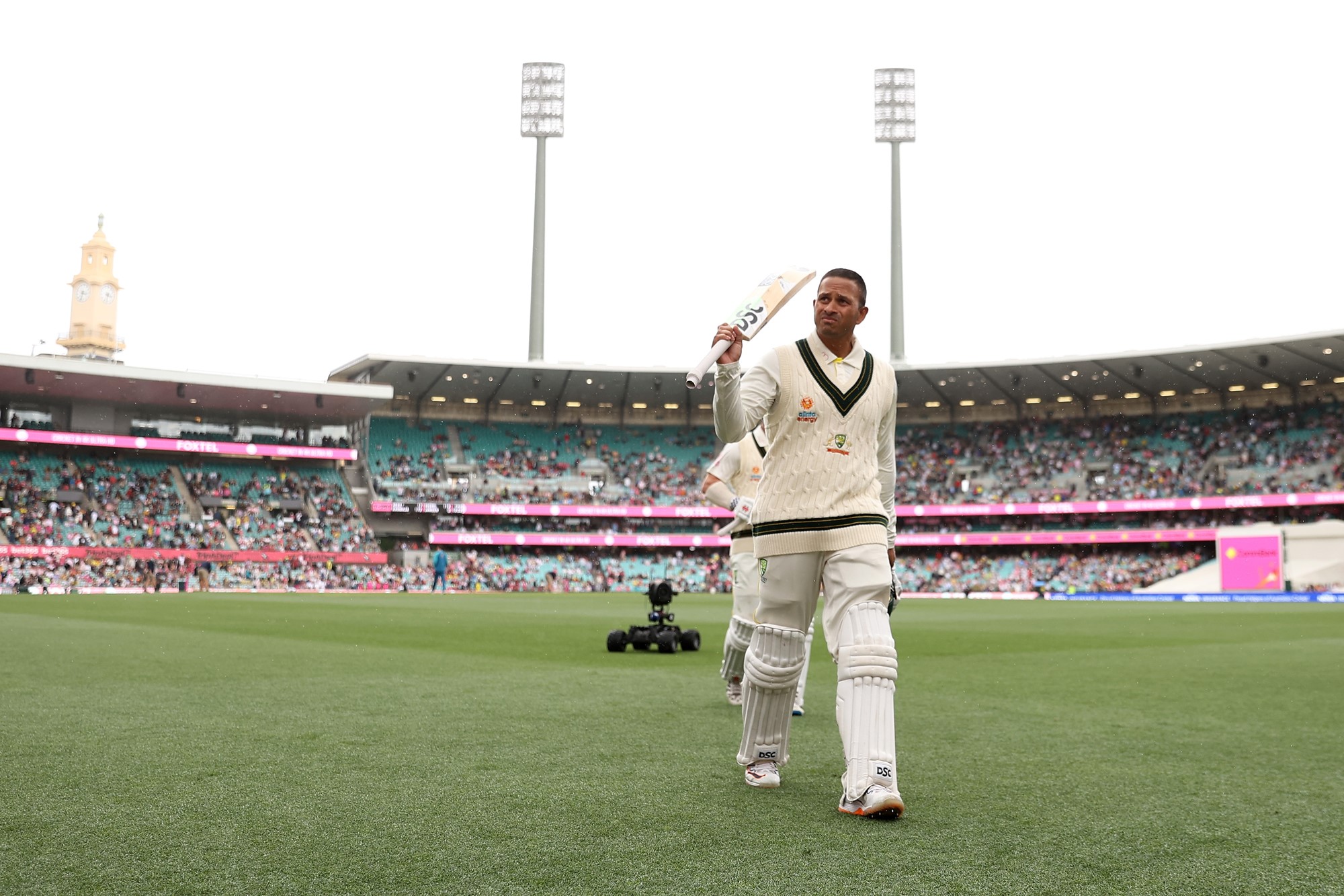 Australia batter Usman Khawaja raises his bat as he walks off the SCG during a Test against South Africa.