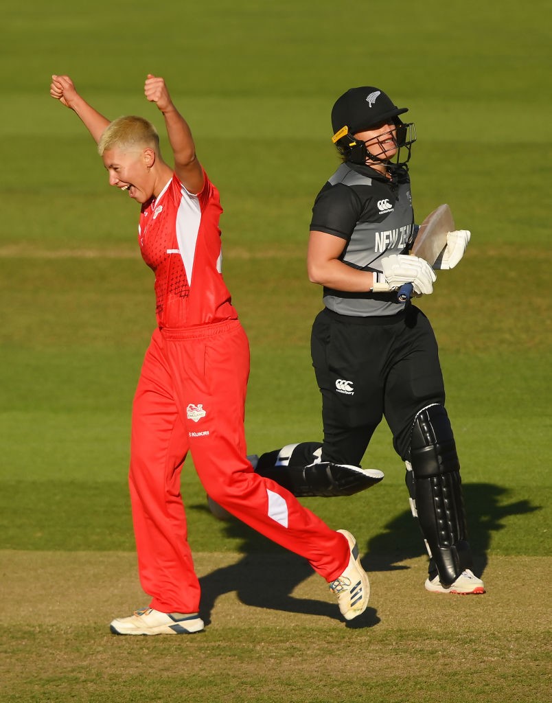 English bowler Issy Wong puts both fists in the air as a New Zealand batter runs off.