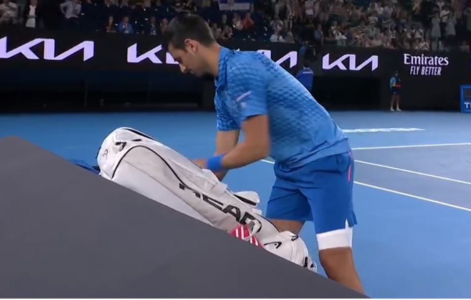 Novak Djokovic grabs a racket