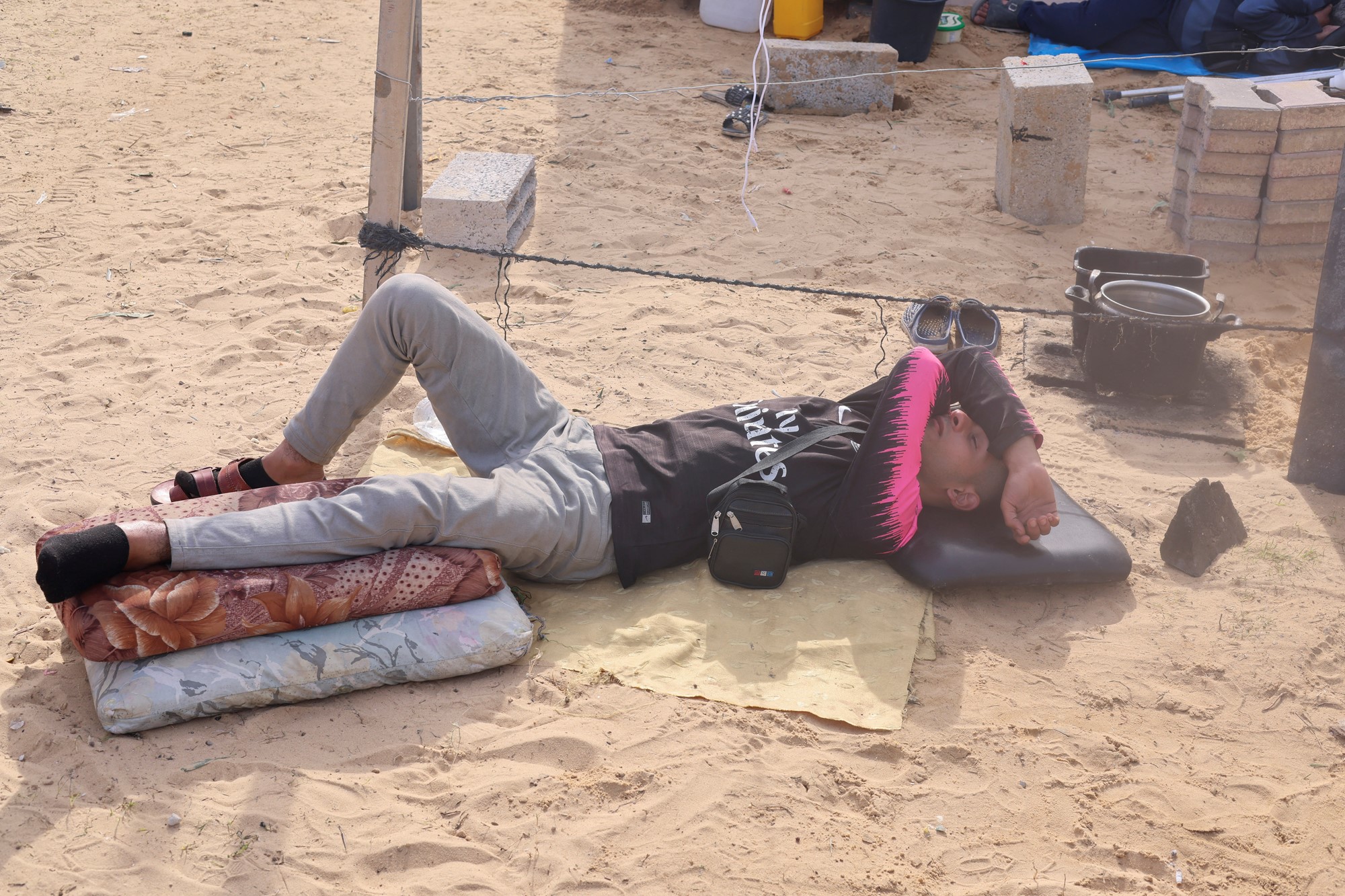 Man lies on the sand ground 