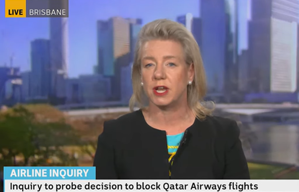 Bridget speaks in a studio with the Brisbane skyline behind her.