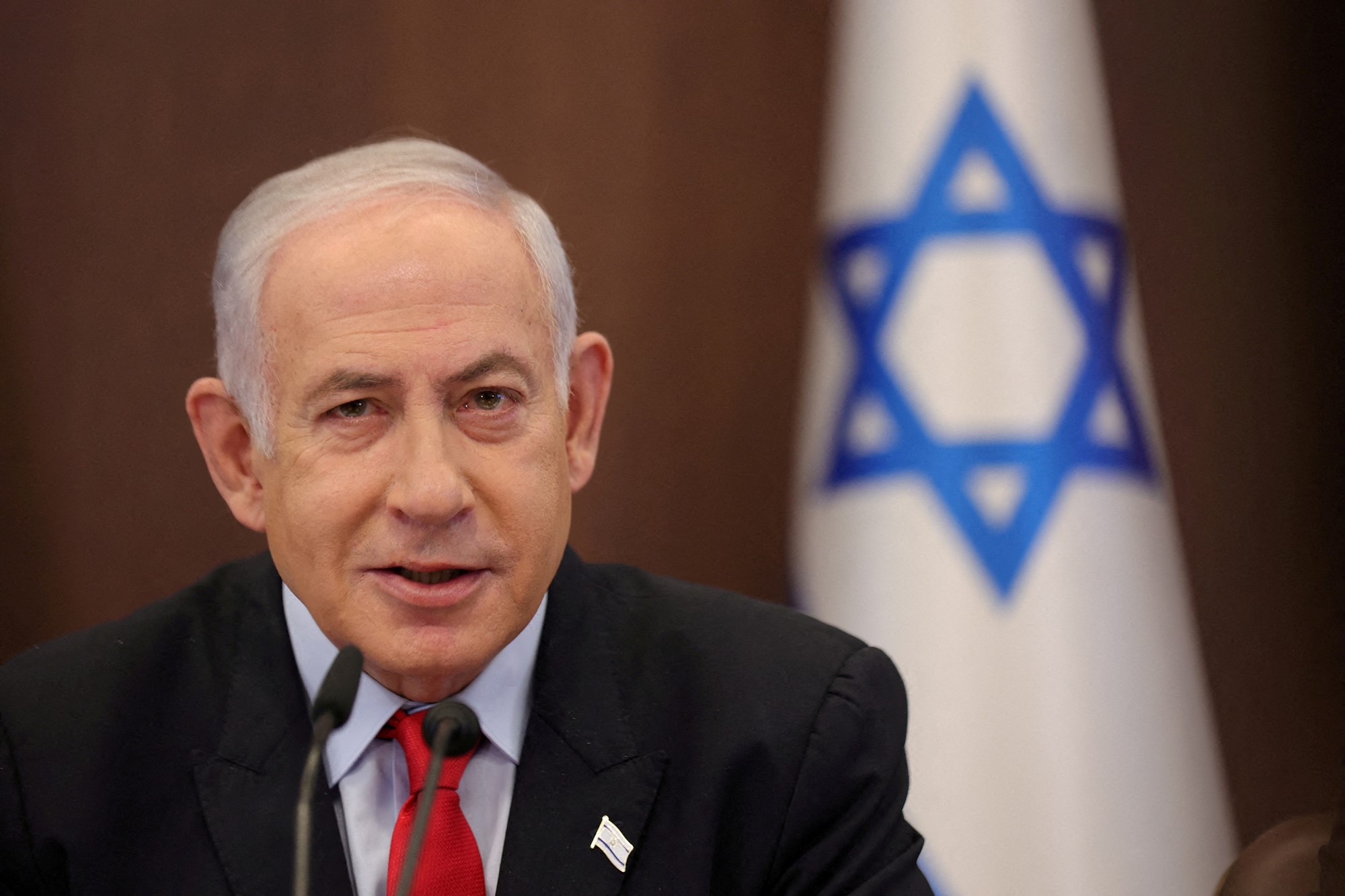 Benjamin Netanyahu in front of the Israeli flag