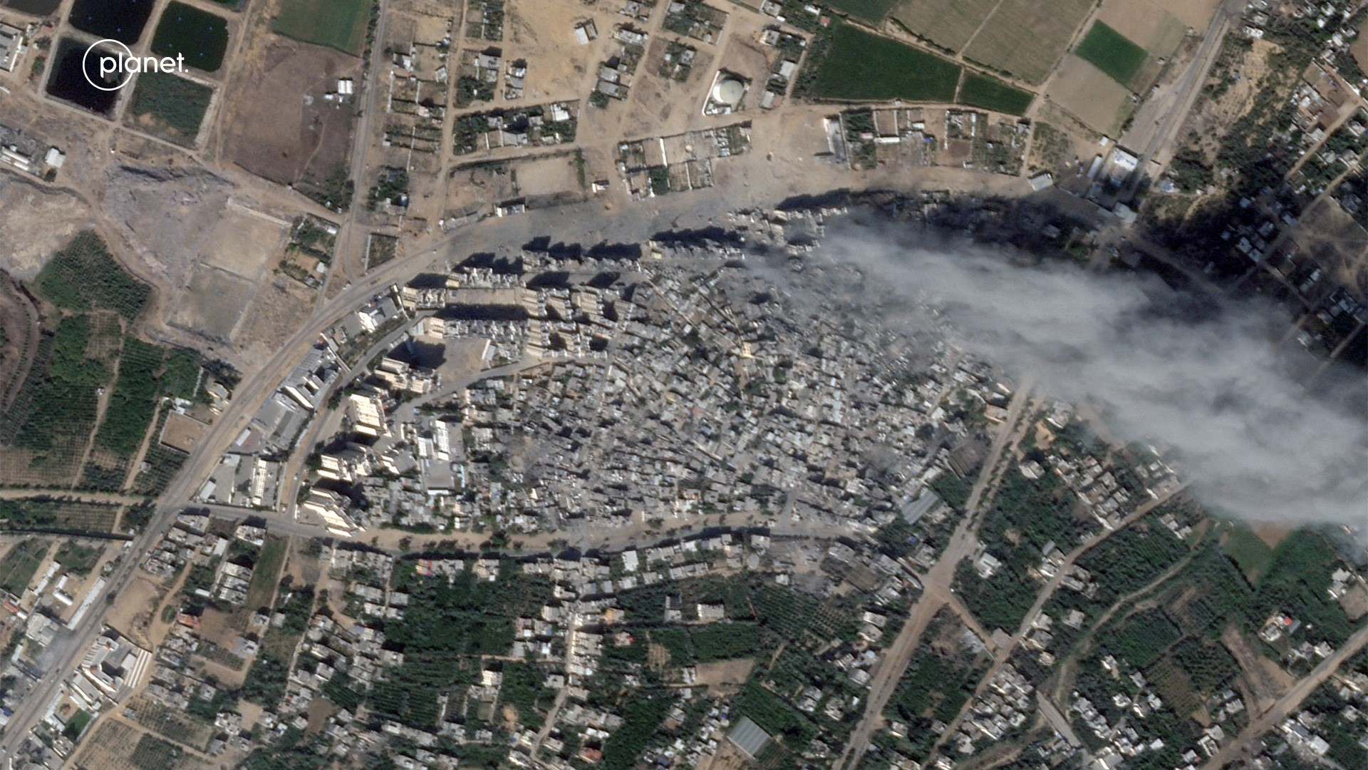 Satellite view of smoke over heavily damaged areas