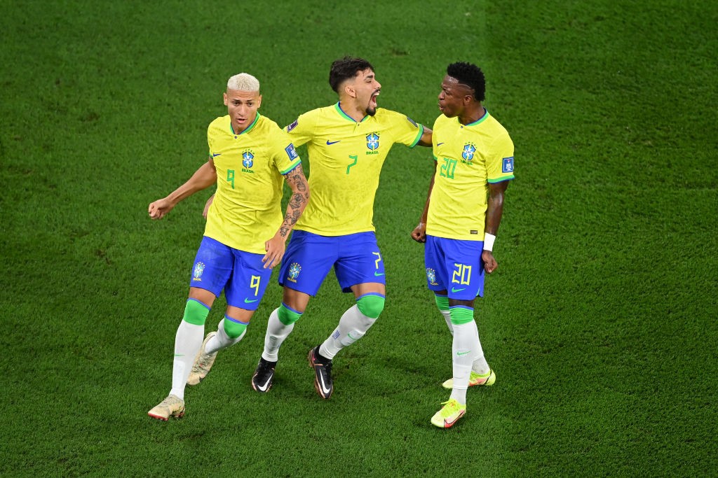 Richarlison, Lucas Paqueta and Vinicius Junior celebrate a goal against South Korea at the World Cup.