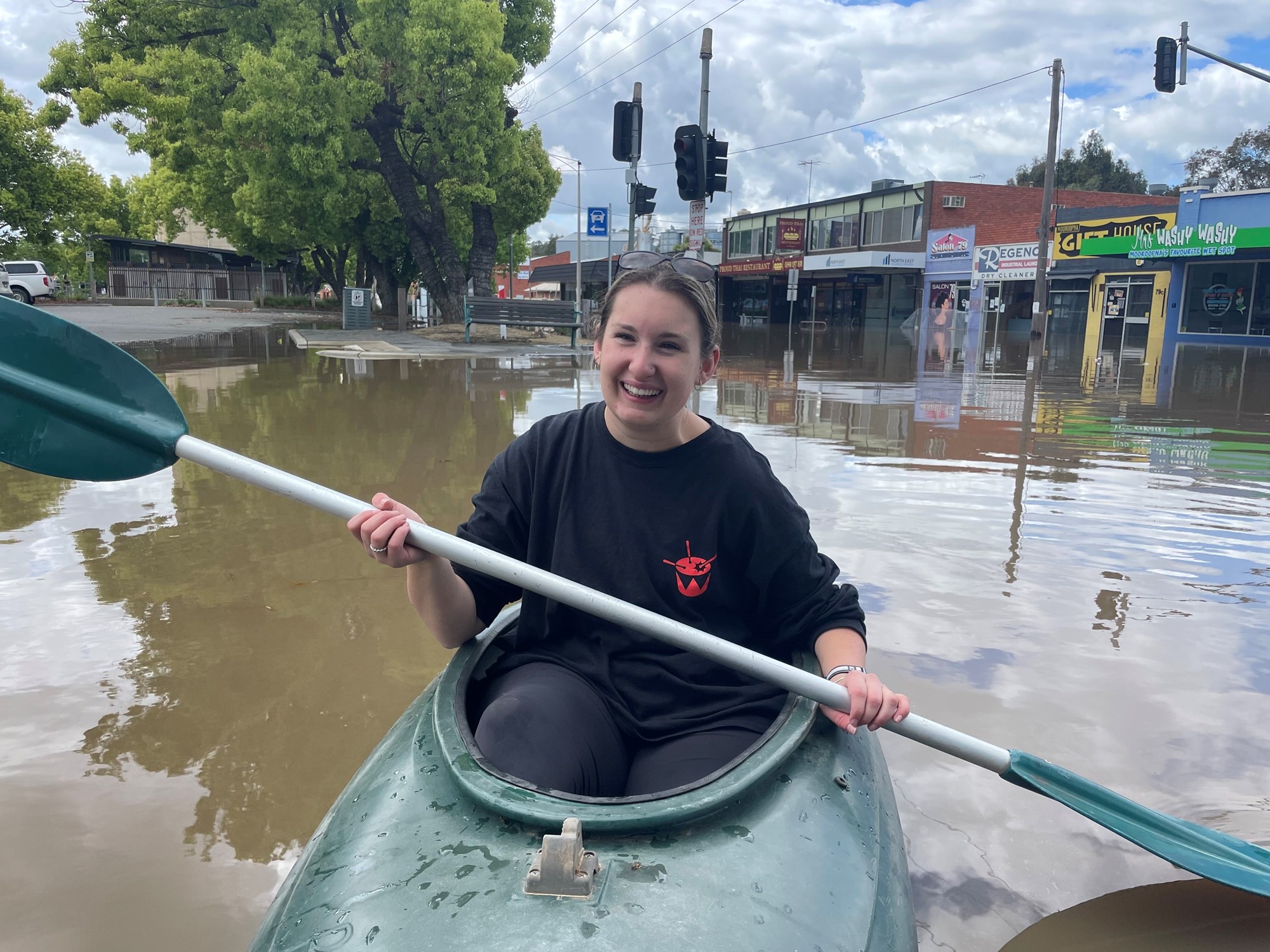 Woman in kayak in flood waters 