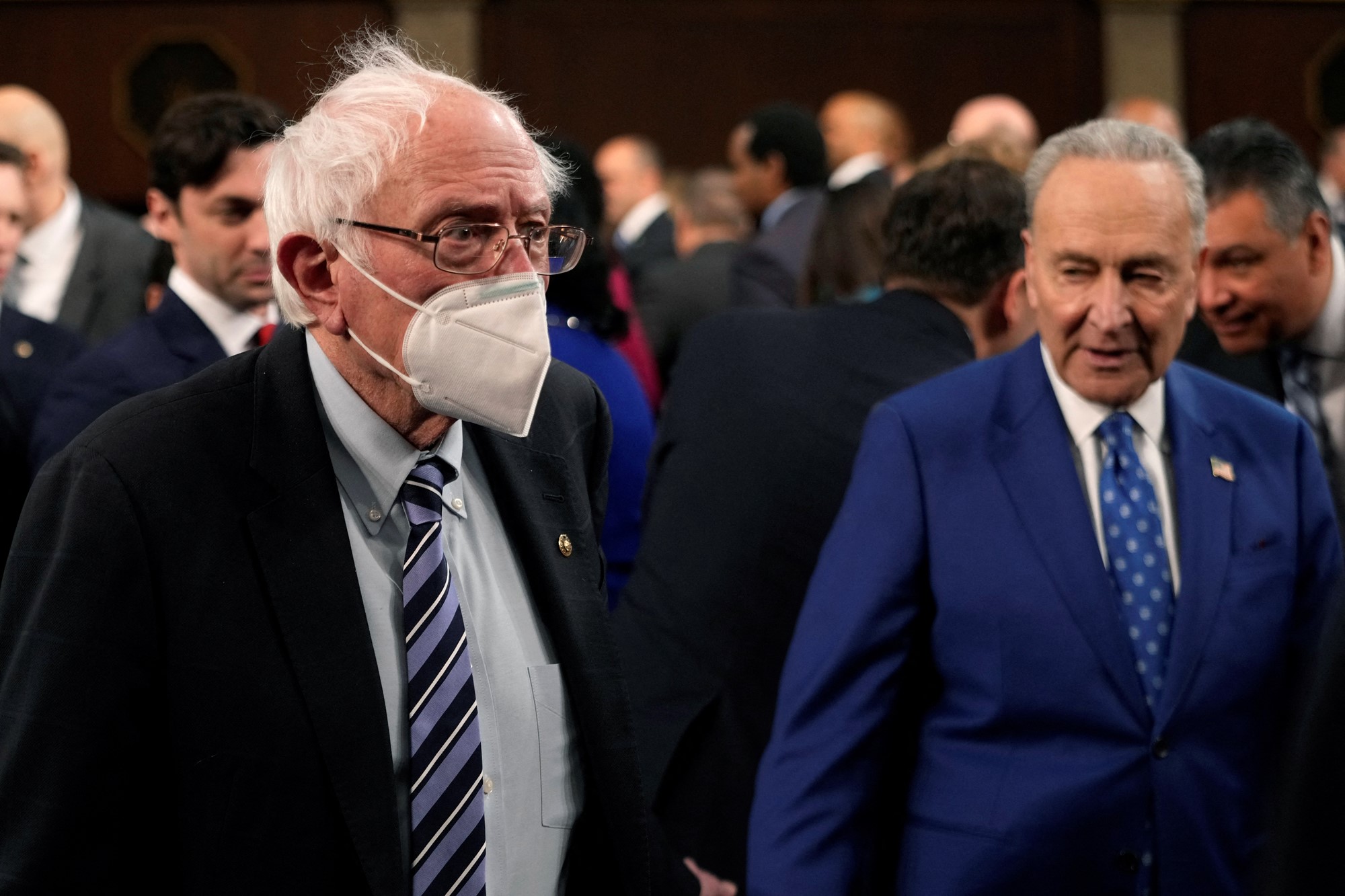 Sanders walks with Chuck Schumer.