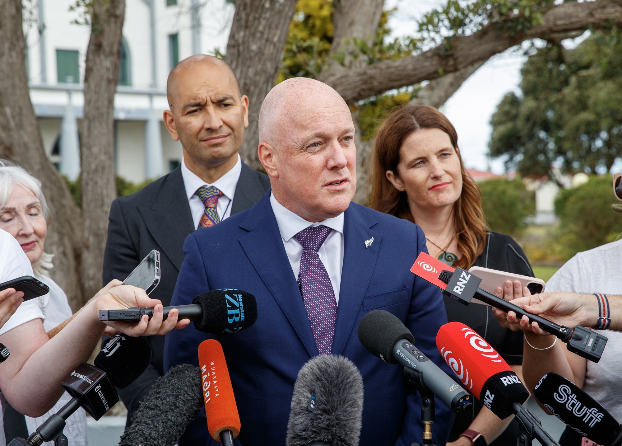 Prime Minister Christopher Luxon, flanked by Māori Affairs Minister Tama Potaka  an Finance Minister Nicola Willis during media standup at Rātana Pā. Photo / Mark Mitchell