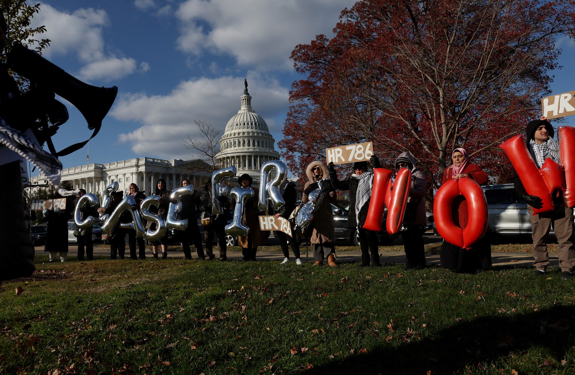 People holding inflated letters which spell CEASEFIRE NOW, outside the Capitol building in Washington DC