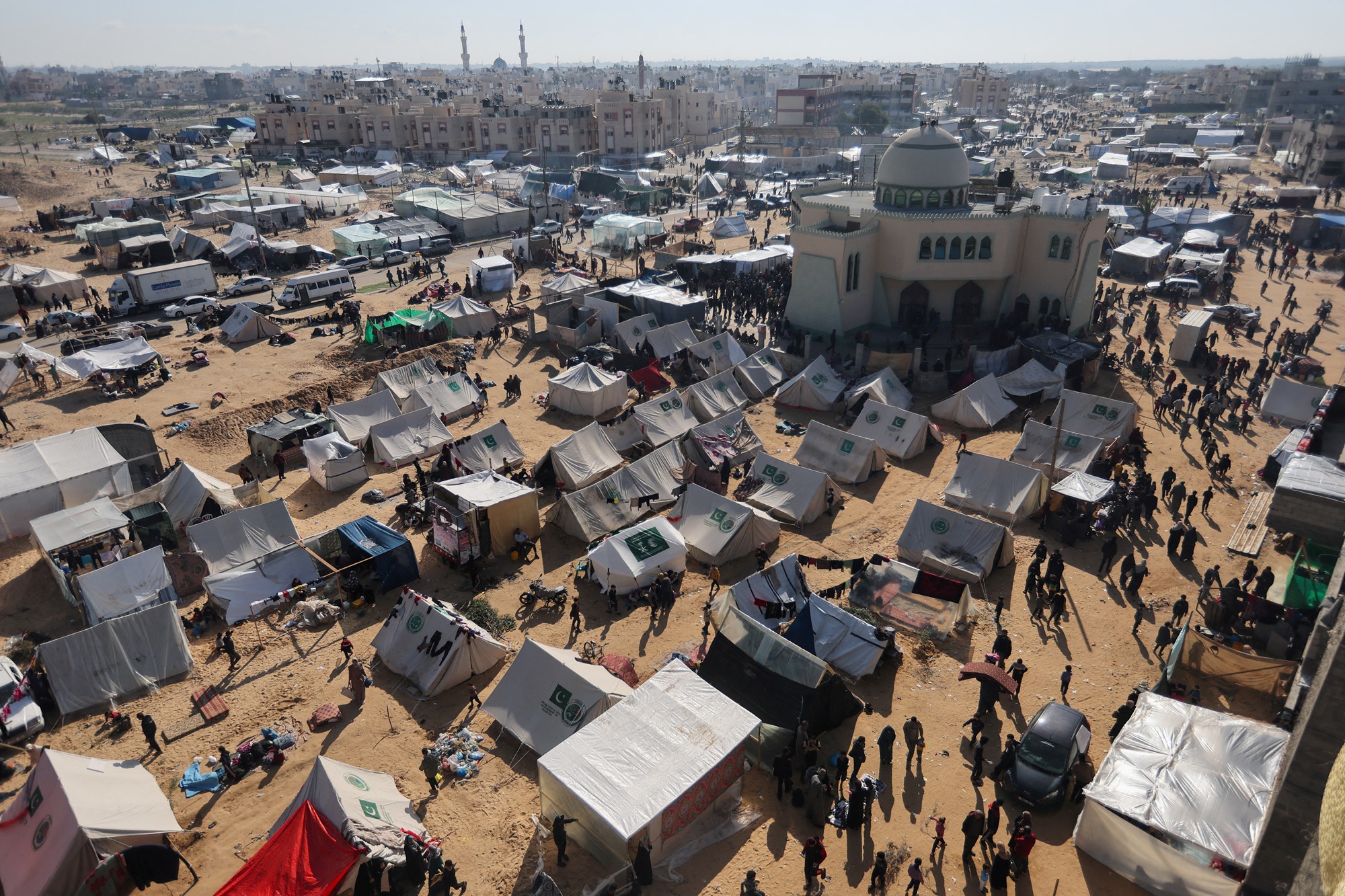 Aerial view of a refugee camp with a mosque in the top right.
