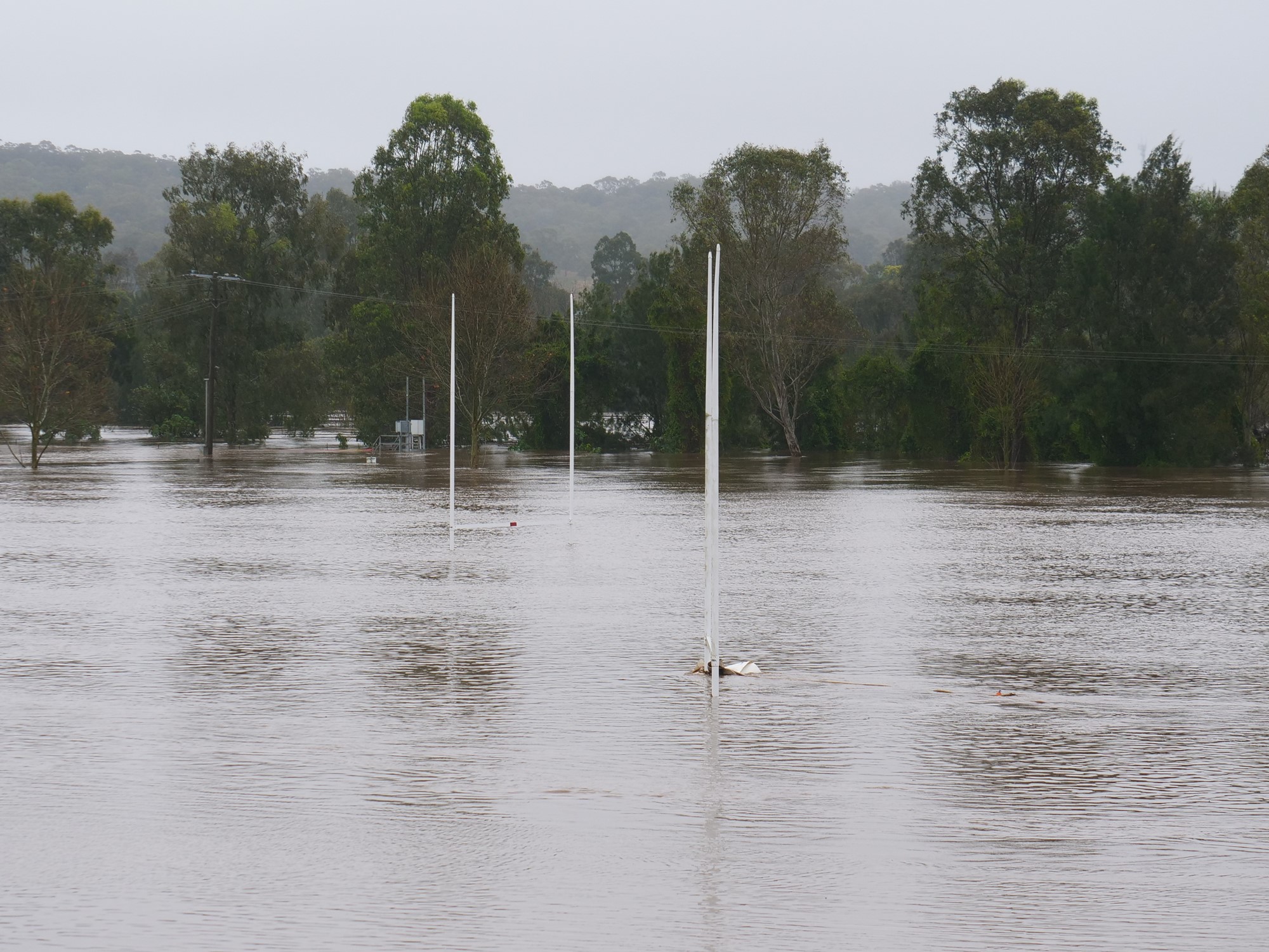 The two white posts of a football goal is see above floodwaters.