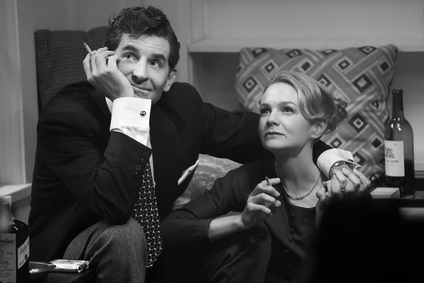 A black and white still from Maestro, featuring the two actors smoking.