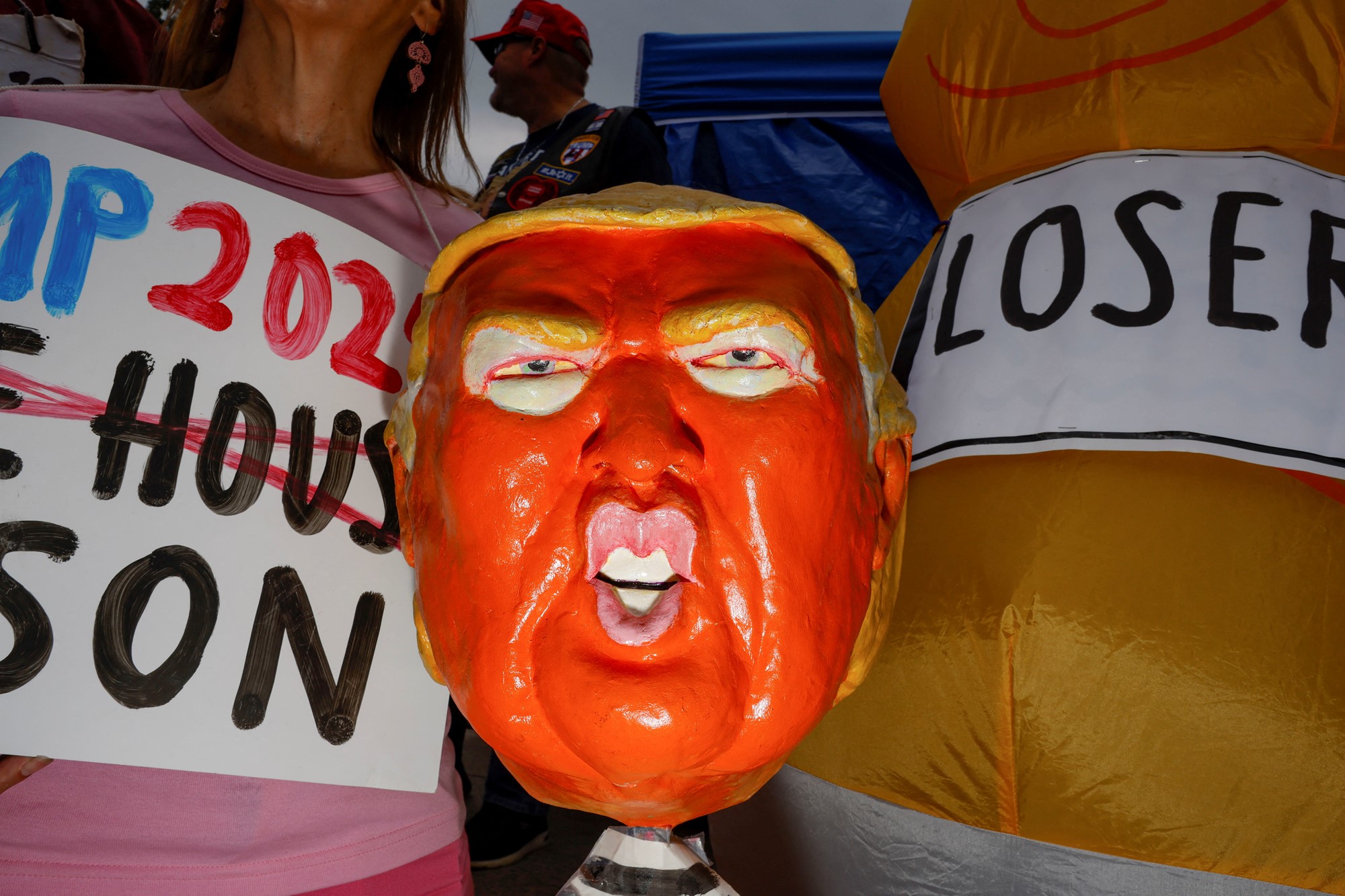 A demonstrator displays a Trump figurine on the day former U.S. President Donald Trump, who is facing federal charges related to attempts to overturn his 2020 election defeat, appears at the U.S. District Court in Washington, U.S., August 3, 2023