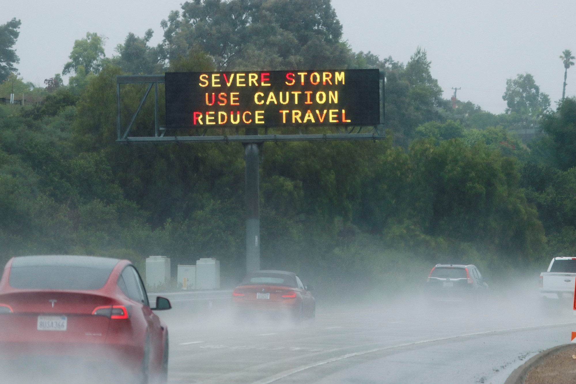 A highway signs read severe storm use caution reduce travel 