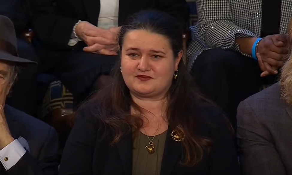 A woman with long dark hair sits in the audience for the State of the Union.