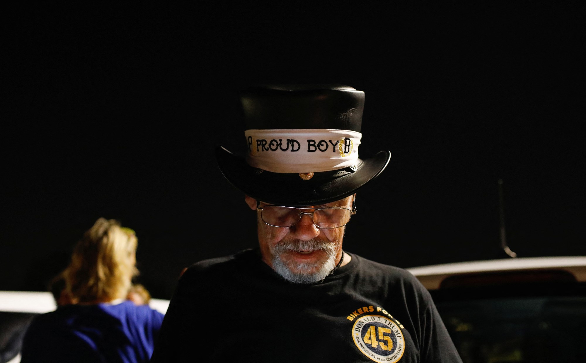 A man wears  a hat that says "proud boys"