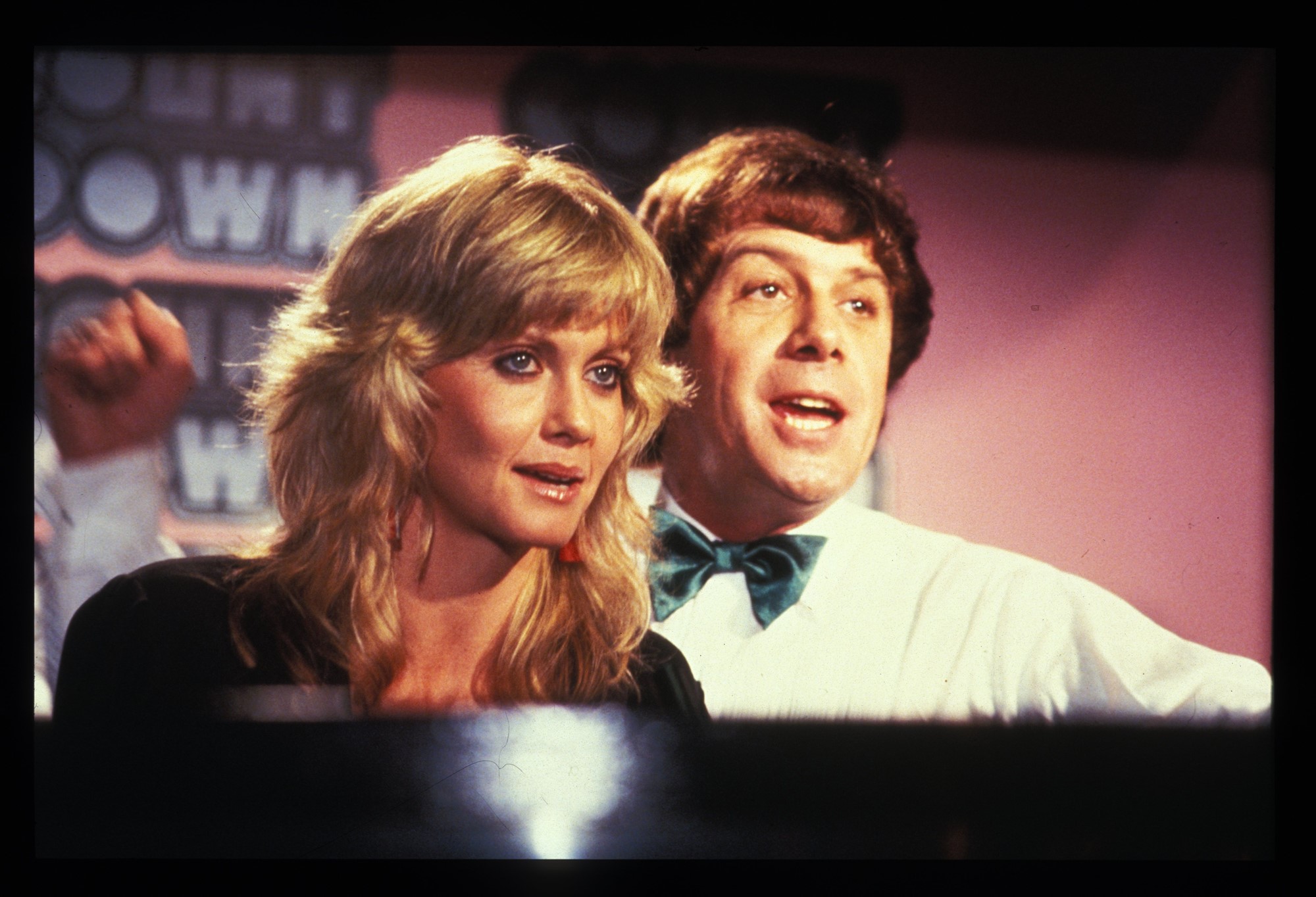 A photo shows Olivia Newton-John and Molly Meldrum performing together.