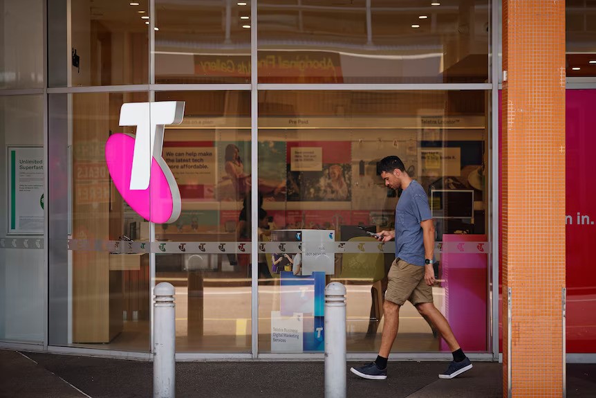 A man walks while on his cellphone.