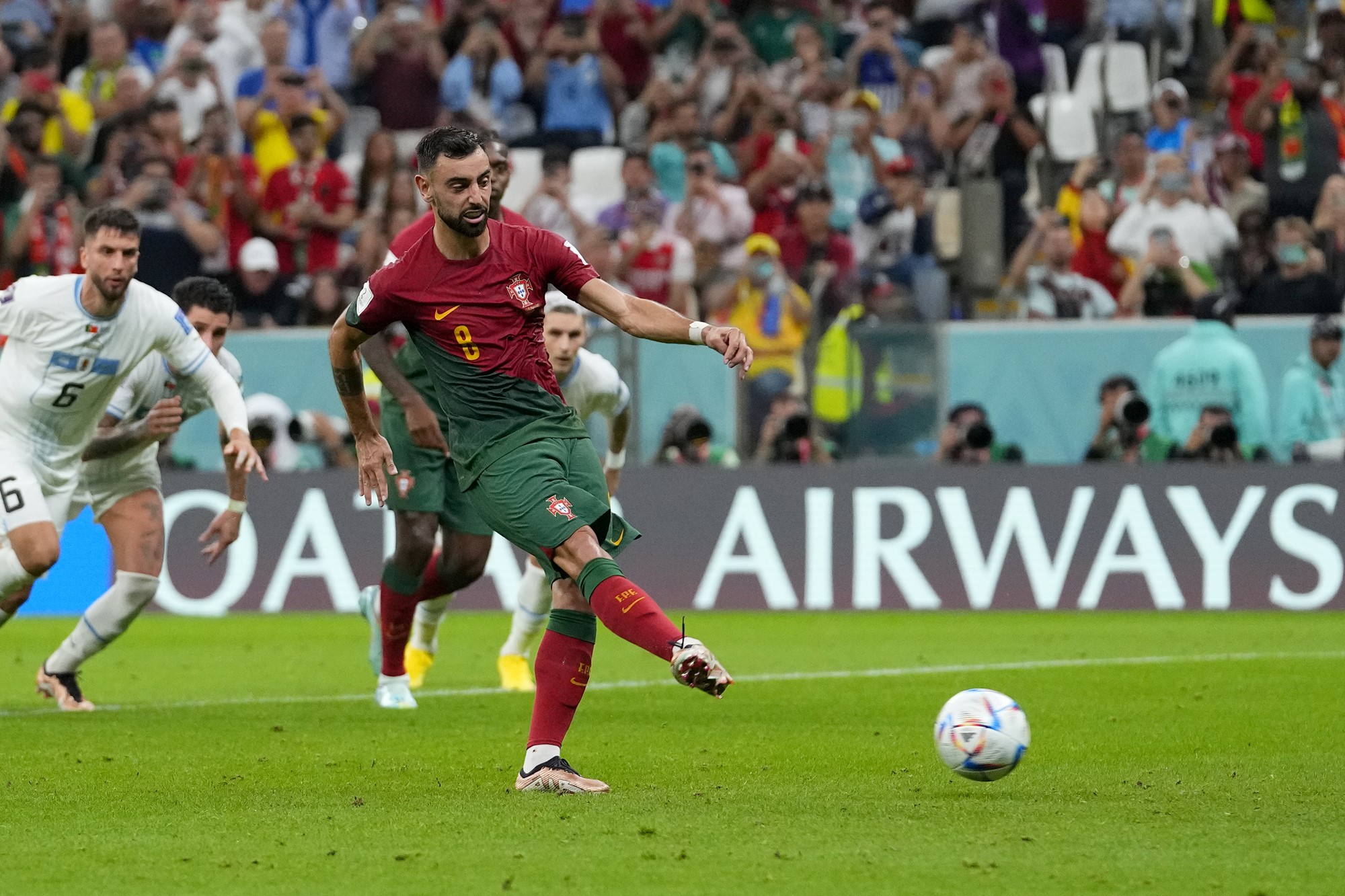 Bruno Fernandes scores from the penalty spot for Portugal against Uruguay.