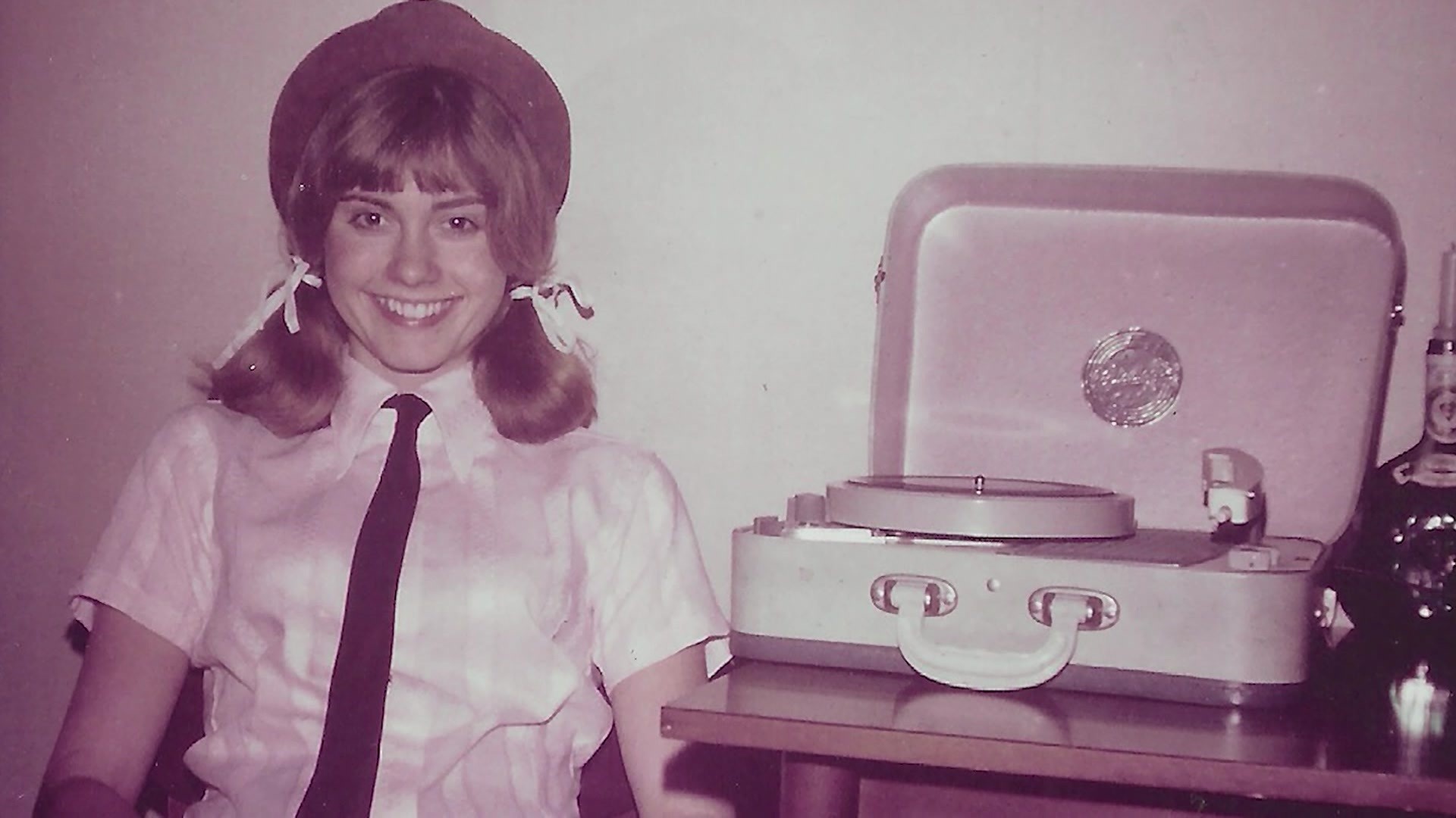 Olivia Newton-John in a sepia-toned photograph, as a young woman.