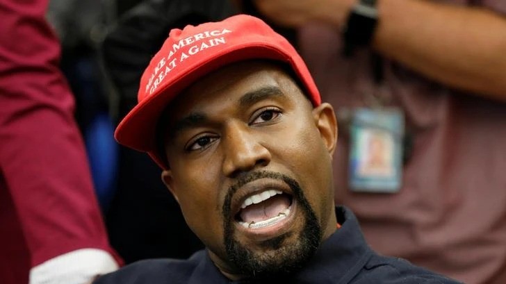 A photo of Kanye West in a Make America Great Again hat.