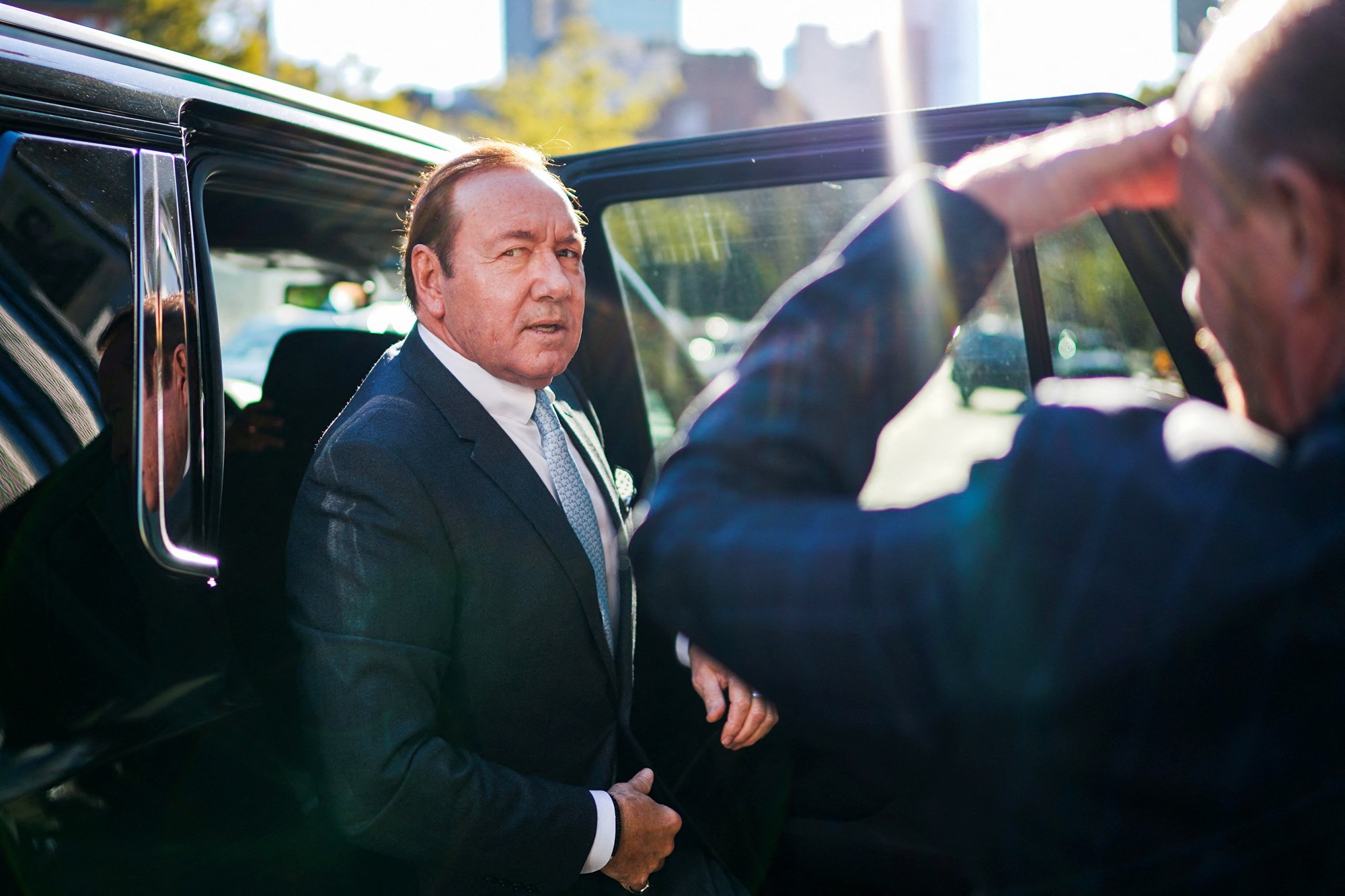 Kevin Spacey steps out of a car.