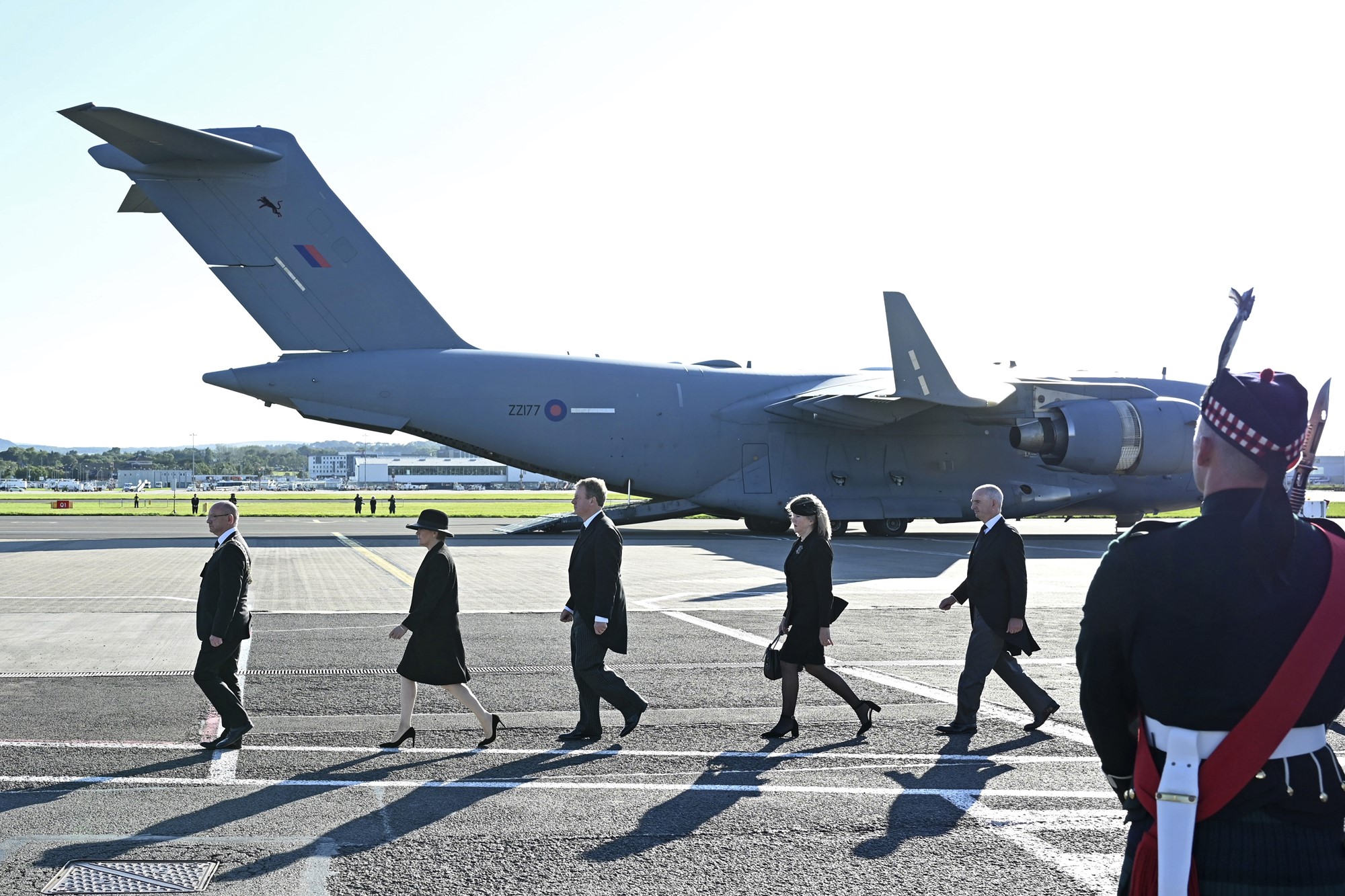 Dignitaries, including Scotland's First Minister Nicola Sturgeon, second left, prepare for the arrival of the coffin of Queen Elizabeth II at Edinburgh airport