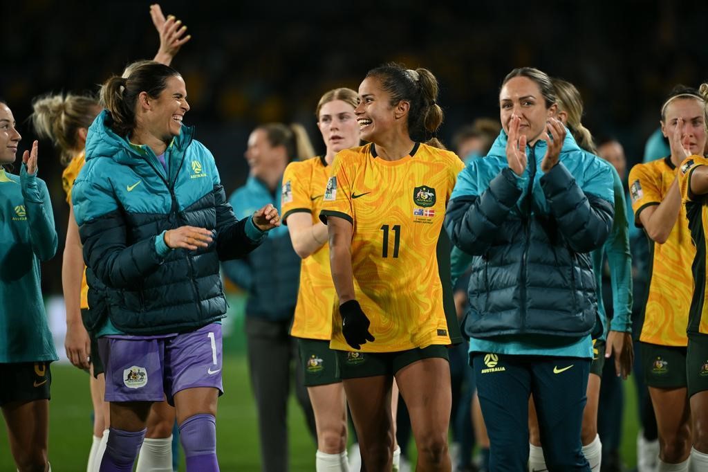 Lydia Williams laughs with Mary Fowler during Australia's lap of honour after beating Denmark at the Women's World Cup.