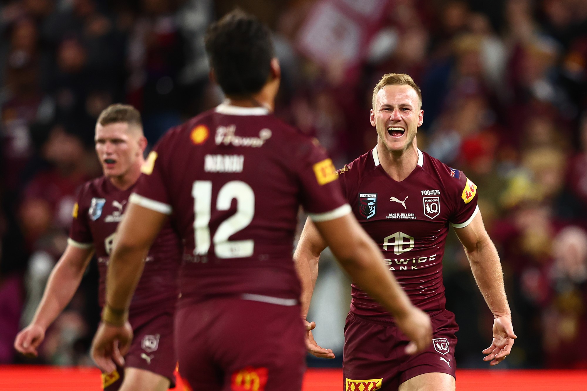 Daly Cherry-Evans smiles, with Jeremia Nanai blurry in the foreground after State of Origin.