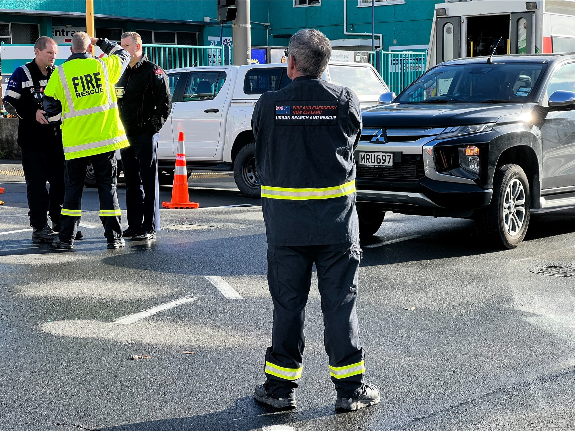 A fireman looks on at his colleagues in the distance