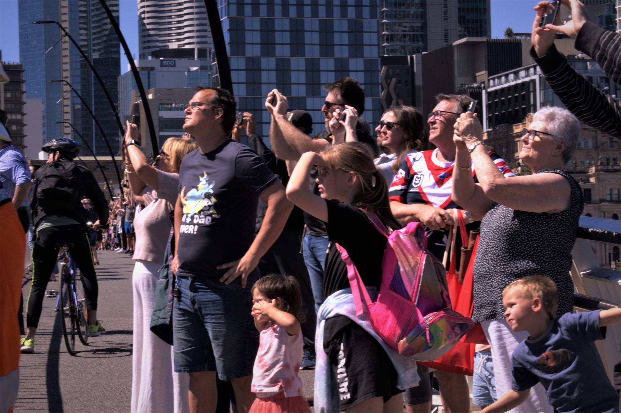 Crowds gather in Brisbane to watch the RAAF flyover.